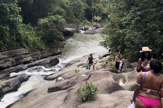 El Yunque Rainforest Party Tour with Waterslide and Rope Swinging - Stop two: a rope swing above a clear lagoon