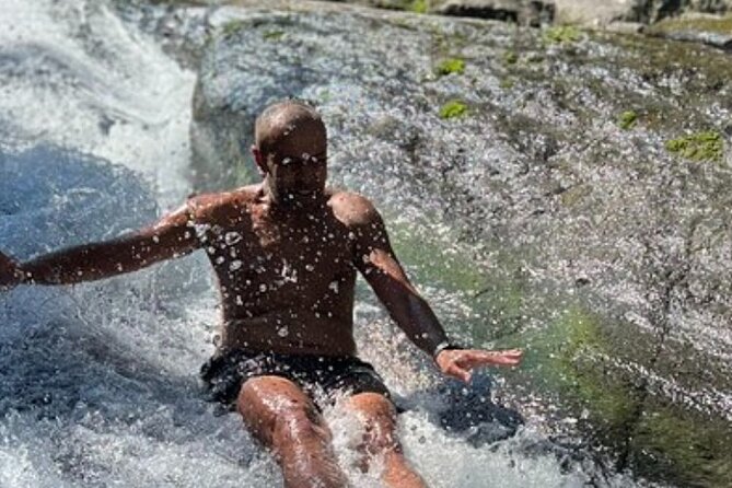El Yunque Rainforest Party Tour with Waterslide and Rope Swinging - Stop one: sliding over El Yunque’s smooth rock